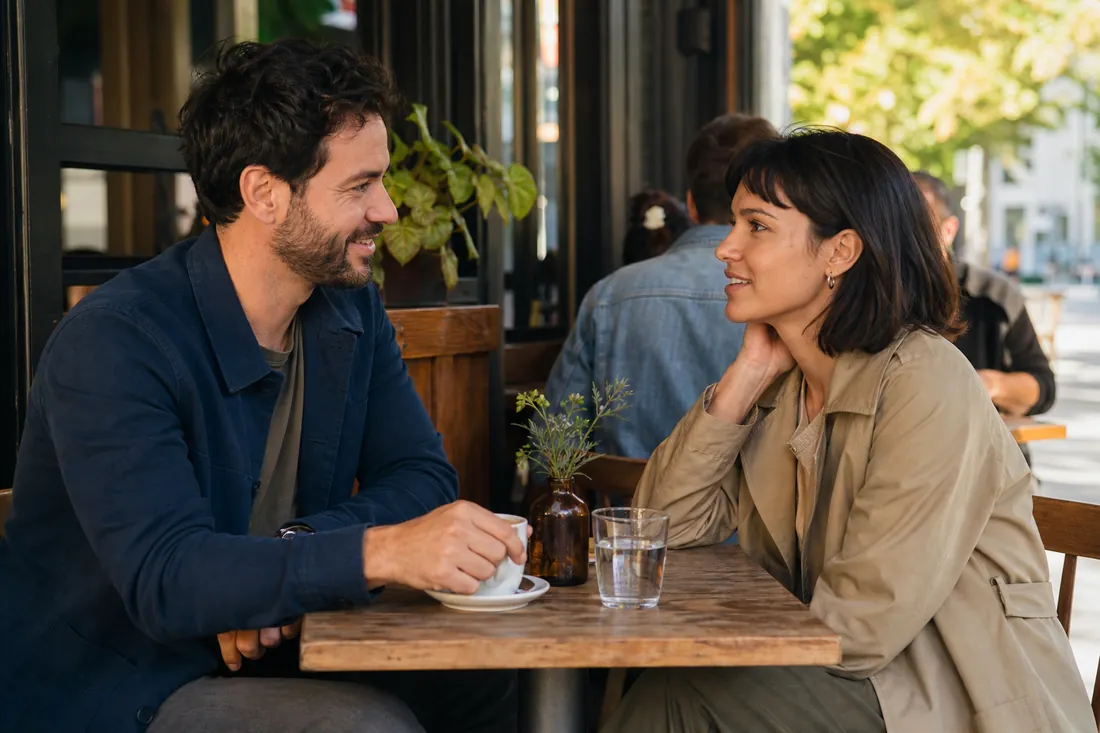 Two adults talking naturally during a casual first meeting at a cafe